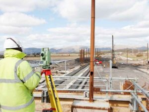 Surveyor performing an ALTA land survey at an industrial site in Henderson Nevada to document existing property conditions.